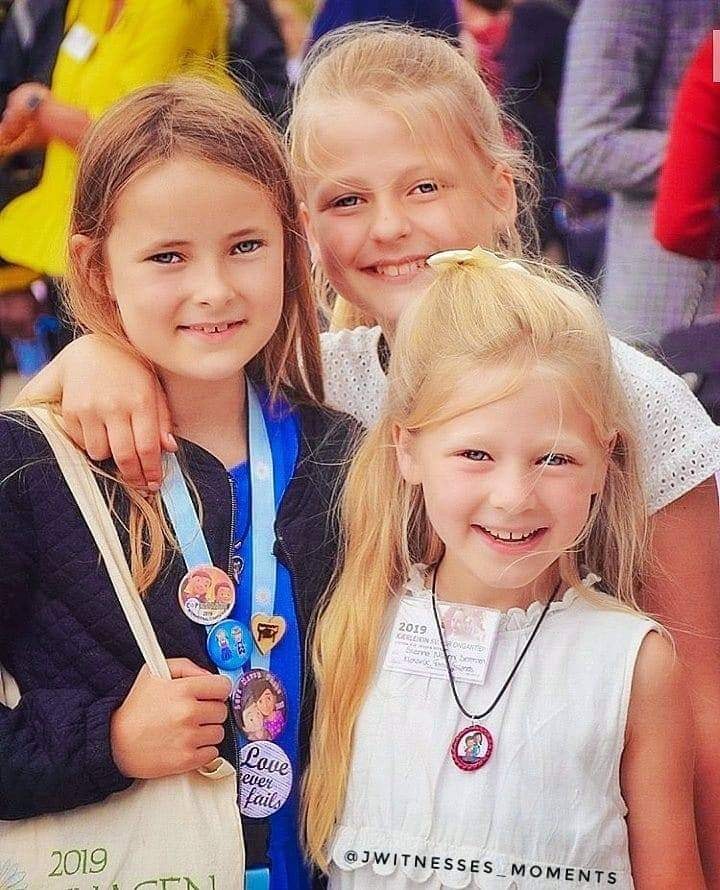 Congregation members outdoors in daylight.